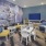 Resident lounge at The District apartments for rent in Pittsburgh, PA, featuring tables, chairs, and a flat screen  TV.